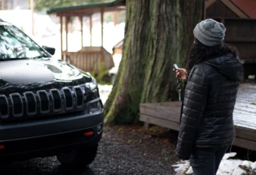 Compustar Remote Starter Winter Hero Driver using a Compustar remote starter beside her vehicle in winter